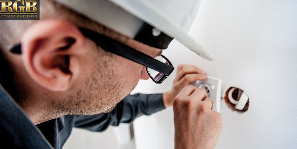 Repairman Repairing Wall Outlet Repairman Repairing Wall Outlet